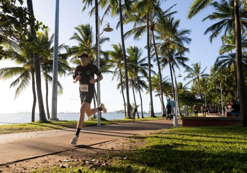 Townsville01_male-competitor-running-along-The-Strand-with-palm-trees-in-the-background-at-Run-Army-Townsville