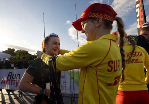 Townsville04_member-of-Surf-Lifesaving-presenting-a-female-runner-with-a-medal-when-she-crosses-the-finish-line
