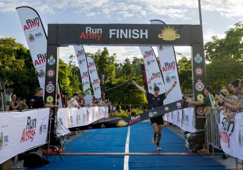 Townsville08_runner-crossing-the-finish-line-with-hands-in-the-air-at-Run-Army-Townsville
